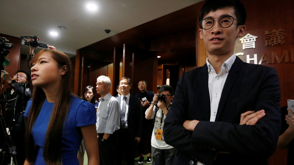 Activists Baggio Leung (R) and Yau Wai-ching (L) stand outside the chamber after pro-Beijing lawmakers staged a walk-out to stall their swearing-in at the Legislative Council in Hong Kong