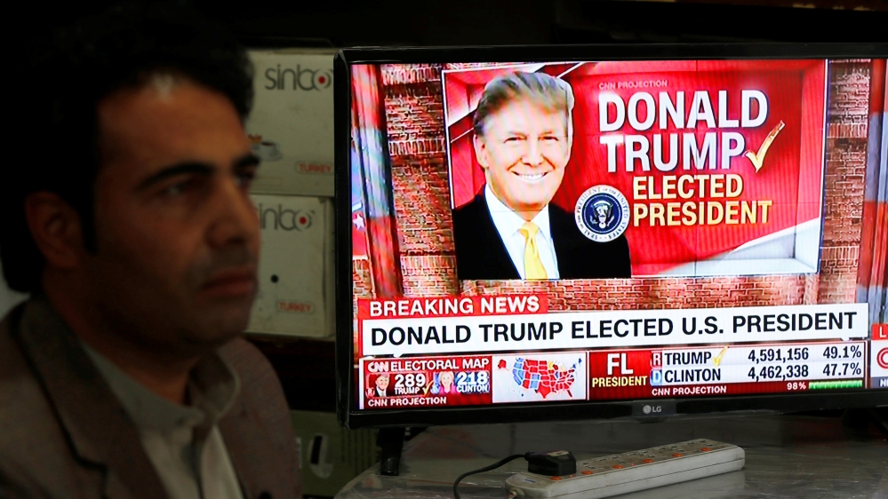 An Afghan man watches broadcasting of the 2016 U.S. presidential election results on TV in Kabul, Afghanistan