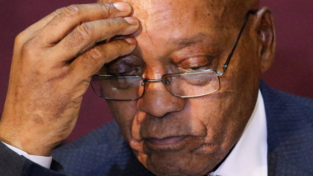South African President Zuma listens at a press conference with President Mugabe in Harare