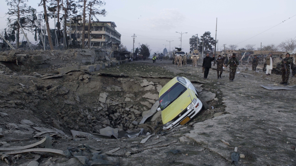 Afghan security forces and NATO troops arrive at the site of explosion near the German consulate office in Mazar-i-Sharif, Afghanistan