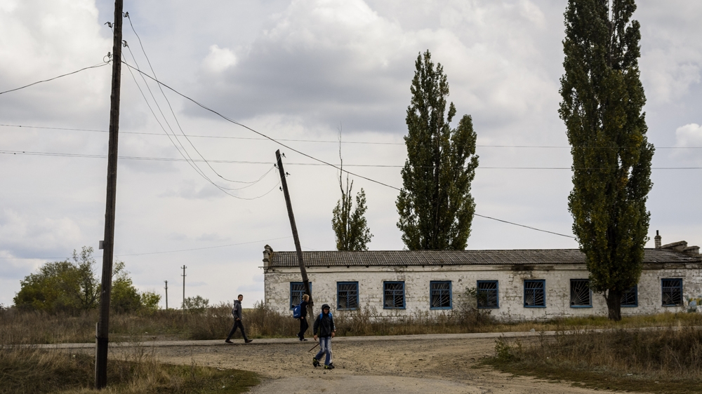 Schoolchildren near Troitske, in the Luhansk region. The village has been at the centre of fighting for a year, and faces a continuing threat from unexploded ordnance [Benas Gerdziunas/Al Jazeera]