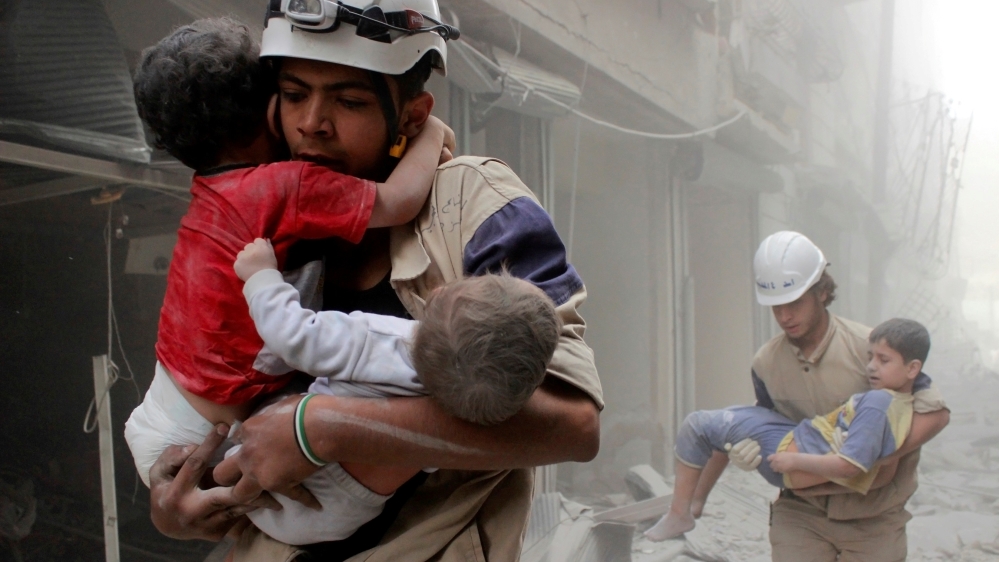 Members of the Civil Defence rescue children after what activists said was an air strike by forces loyal to Syria''s President Assad in al-Shaar neighbourhood of Aleppo