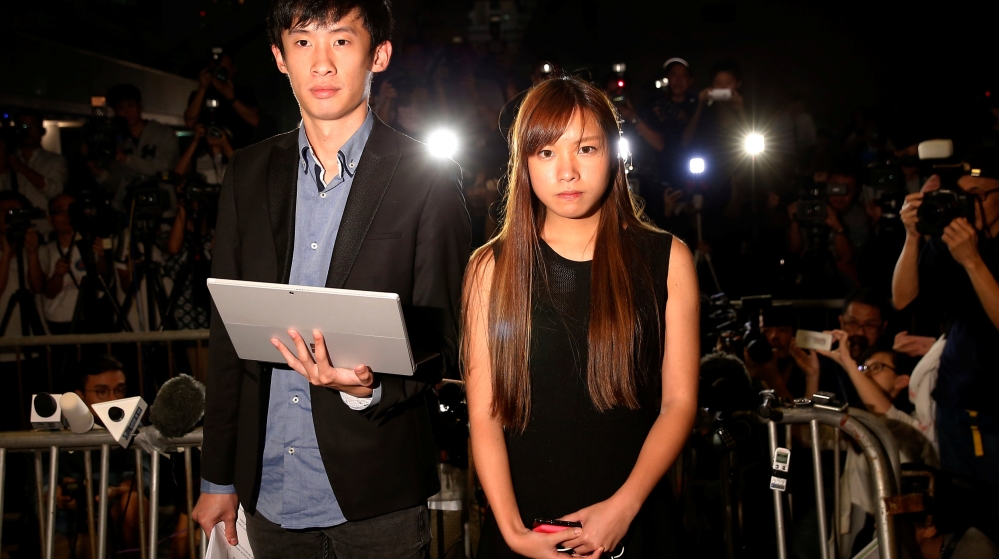 Democratically-elected legislators Yau Wai-Ching and Baggio Leung (L) speak to media after High Court disqualified them from taking office in Hong Kong