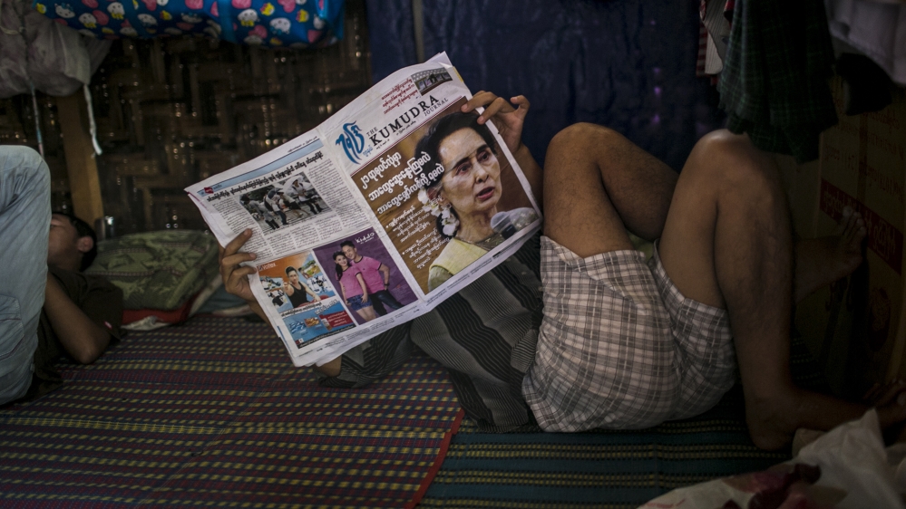 
Aung San Suu Kyi on the front page of a local newspaper. Support for the de-facto leader of Myanmar has become low in Kachin state as many believe that the government does not do enough to support the Kachin people [David Shaw/Al Jazeera]
