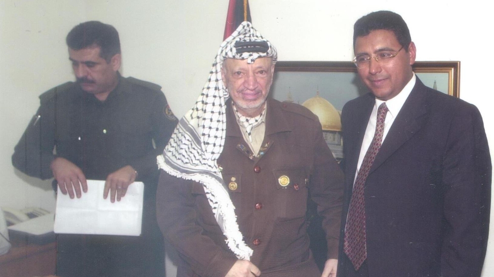 Al Jazeera journalist Mahmoud Hussein, pictured right, is currently languishing in an Egyptian jail on false charges [Al Jazeera]