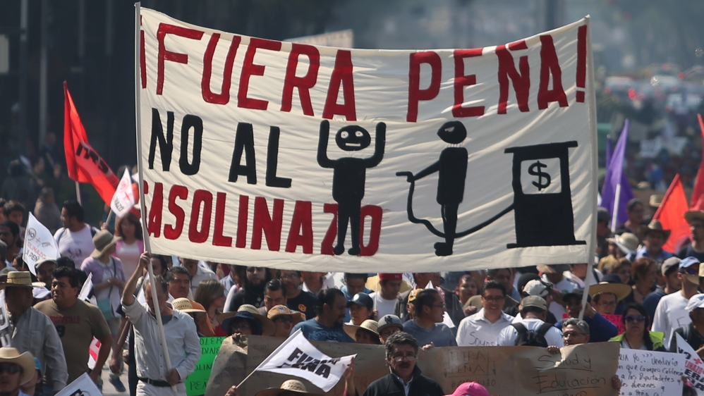 Protesters march during a demonstration against the rising prices of gasoline enforced by the Mexican government at downtown in Mexico City