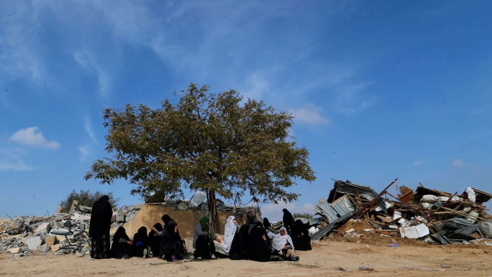 Arab Israeli women sit next to ruins from their dwellings which were demolished by Israeli bulldozers in Umm Al-Hiran, a Bedouin village in Israel''s southern Negev Desert