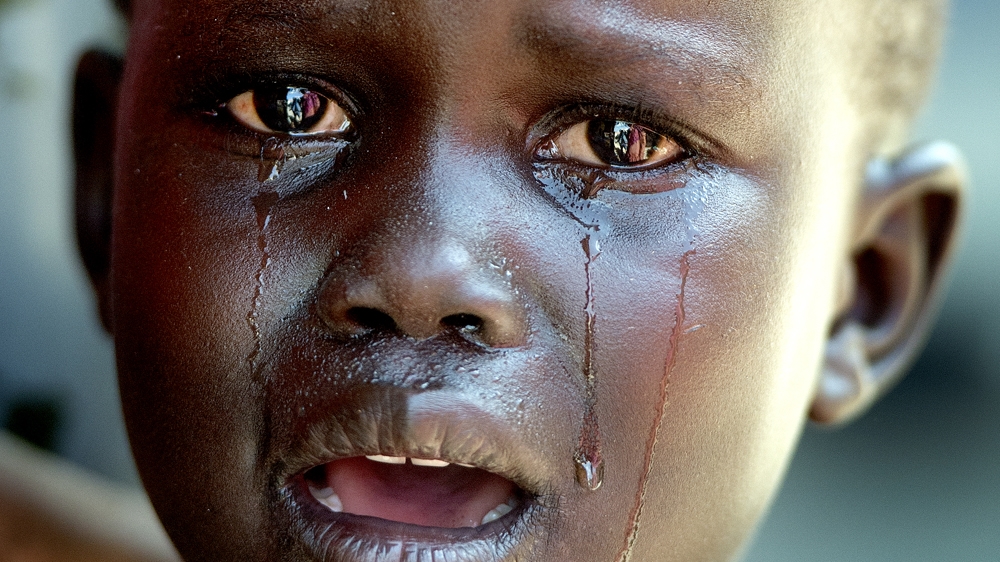  Upon arrival in Uganda, aid agencies offer vaccinations to children. Here, a child in Afoji town cries before, during, and after her injection [Yilmaz Polat/Al Jazeera] 