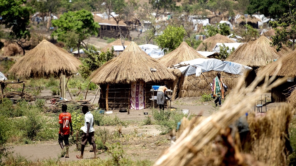 In theory, 30 square metre plots of land should be allocated in the settlements, but in reality the huts are built in close proximity [Yilmaz Polat/Al Jazeera]Plastic, an abundant material in the settlements, is used to make toys. Footballs are created by stringing together plastic bags [Yilmaz Polat/Al Jazeera]Kapenta fish are sold in Bidibidi settlement's market. For most South Sudanese, this small fish is the staple of their meals [Yilmaz Polat/Al Jazeera] The Bidibidi settlement seen from the top of a hill. [Yilmaz Polat/Al Jazeera] Children in the Adjumani settlement entertain themselves playing football [Yilmaz Polat/Al Jazeera] Two boys from the Dinka tribe walk arm in arm in the Adjumani settlement [Yilmaz Polat/Al Jazeera]A woman in the Bidibidi settlement. Many of the refugees are fleeing for the second or third time in their lives [Yilmaz Polat/Al Jazeera]Simon Marchiek in the Adjumani settlement. This is the seventh time Simon has fled his home in South Sudan [Yilmaz Polat/Al Jazeera]Rose Tamaka shops for tomatoes and fish at the market in Bidibidi settlement [Yilmaz Polat/Al Jazeera]A road outside the Bidibidi settlement [Yilmaz Polat/Al Jazeera]A truck is loaded with refugees in Afoji town before being driven out to settlements [Yilmaz Polat/Al Jazeera]Fifty-four-year old Moses Nyaya [Yilmaz Polat/Al Jazeera] Residents line up their jerry cans, filling up in turn until there is no more water [Yilmaz Polat/Al Jazeera]Emmanuel Malice is constantly tired. At night, he is haunted by nightmares, the sounds of gunshots making up the soundtrack [Yilmaz Polat/Al Jazeera]Bloated stomachs in the camp are a symptom of malnutrition [Yilmaz Polat/Al Jazeera]Children carry water and food from the aid centres at the bottom of the hill [Yilmaz Polat/Al Jazeera]