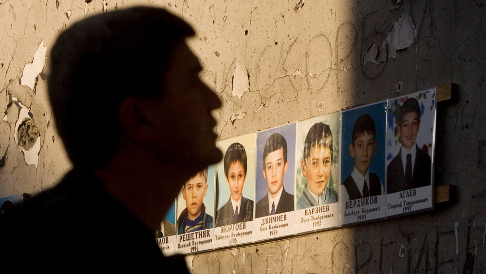 FILE PHOTO - A man mourns inside the Beslan school gymnasium