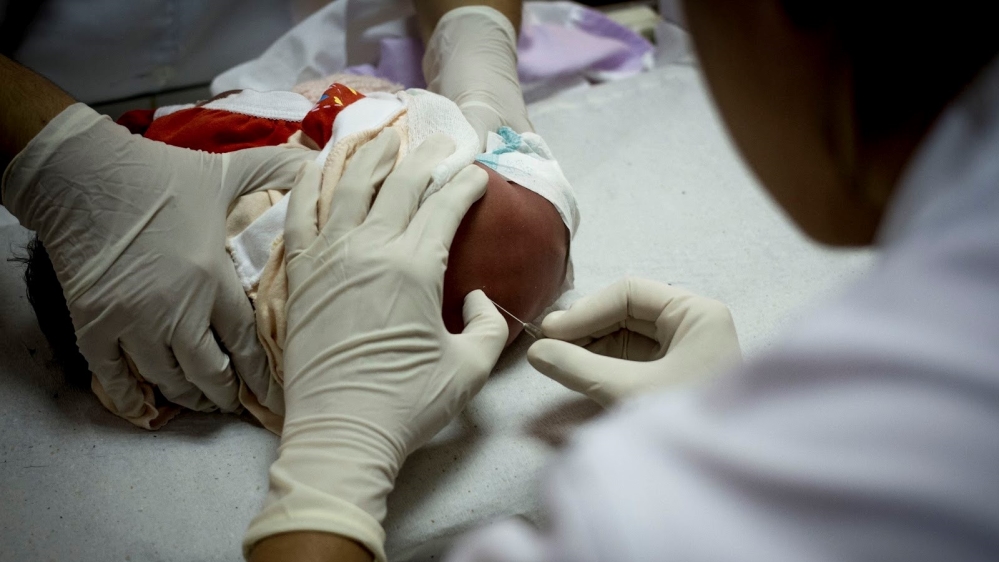 Doctors collect cerebral fluids from the spine of Debora's baby, born with neurosyphilis, to assess his condition [Courtesy of Heudes Regis]