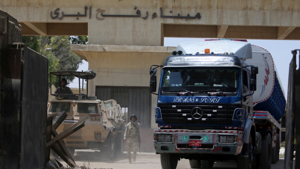 Egyptian soldiers stand guard at the border as fuel tankers enter Gaza through the Rafah border between Egypt and southern Gaza Strip
