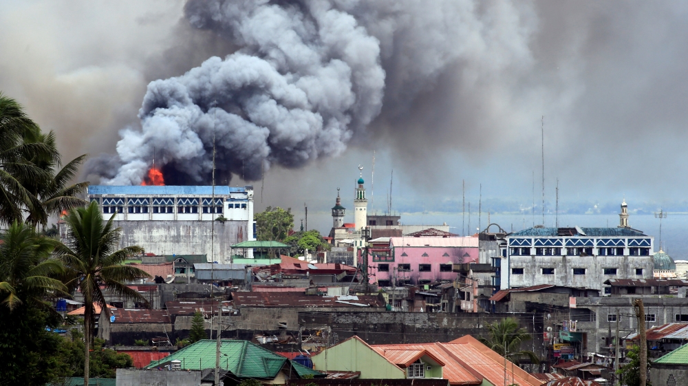 Black smoke comes from a burning building in a commercial area of Osmena street in Marawi city