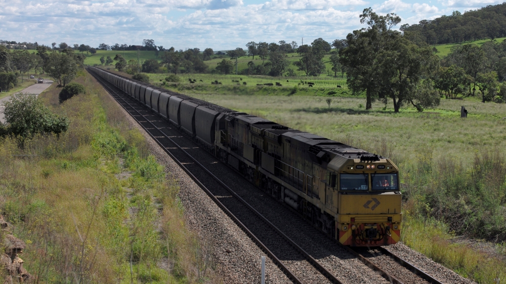 An Aurizon coal train travels through the countryside in Muswellbrook, north of Sydney, Australia
