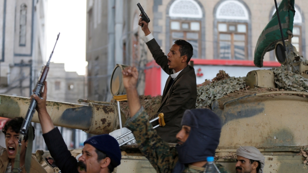 Houthi militants react as they gather next to a tank after the death of Yemen''s former president Ali Abdullah Saleh, in Sanaa