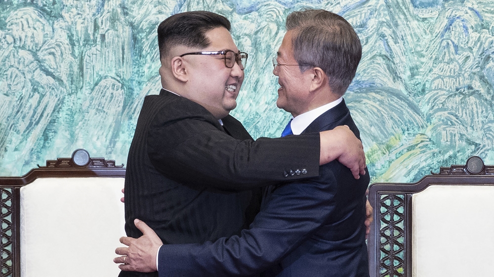 North Korean leader Kim Jong Un, left, and South Korean President Moon Jae-in embrace each other after signing on a joint statement at the border village of Panmunjom in the Demilitarized Zone, South Korea, Friday, April 27, 2018.