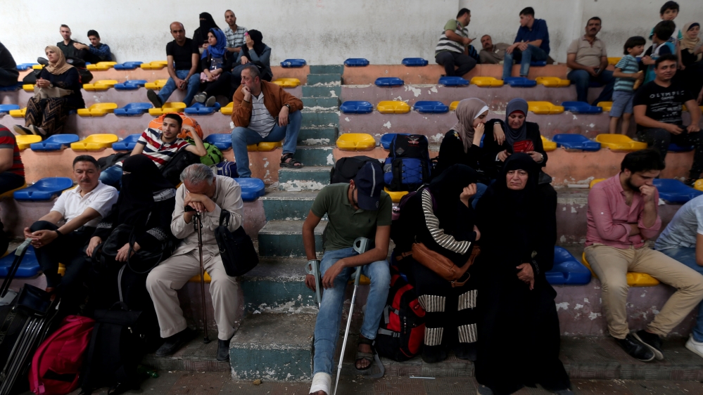 Palestinians wait to travel to Egypt through the Rafah border crossing, in the southern Gaza Strip