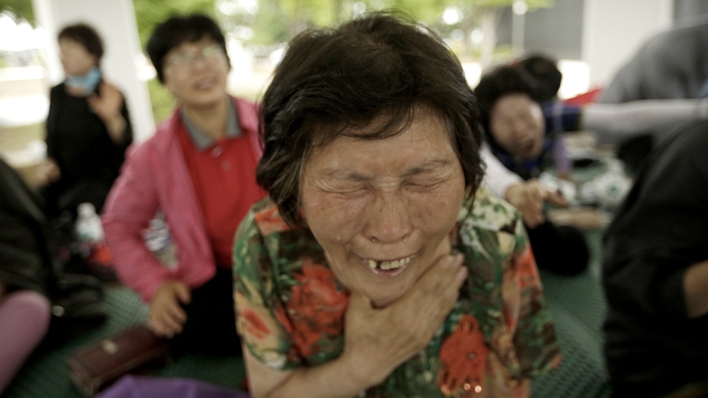 A Christian woman prays during a service wishing for peace on the Korean Peninsula at the Imjingak Pavilion in Paju near the border village of Panmunjom, South Korea [Ahn Young-joon/The Associated Press]