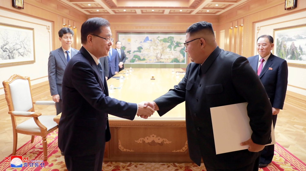 A South Korean envoy shakes hands with North Korean leader Kim Jong Un during their meeting in Pyongyang
