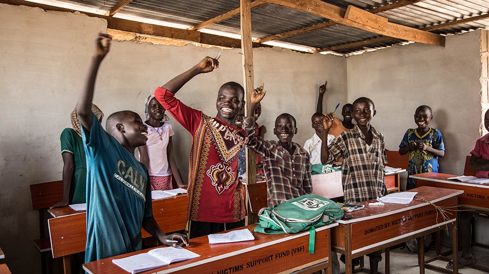 Students at the Education Must Continue Initaitive school in Yola raise their hands when asked if they want to become soldiers [Chika Oduah/Al Jazeera]