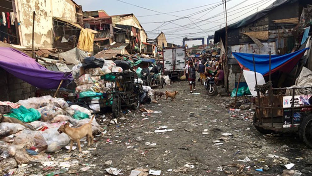 Thousands have built homes in a rubbish dump in Tondo, Manila's largest slum, where they make a living scavenging recyclables to resell [Anne Bouleanu/Al Jazeera]