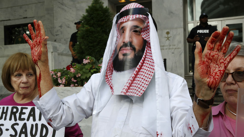 An activist wears a mask with Saudi Arabia Crown Prince Mohammed bin Salman image during a protest outside Saudi Arabia’s embassy in Washington, DC in 2018