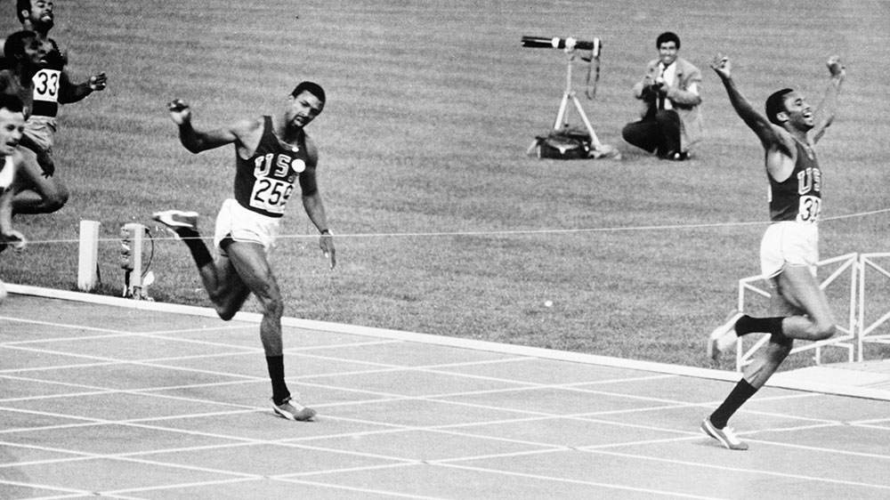 Tommie Smith, right, of the USA wins the men's 200 metres final at the 1968 Olympic Games in Mexico City. Bronze medalist John Carlos, also of the USA, is on the left [File: Douglas Miller/Keystone/Hulton Archive/Getty Images] 
