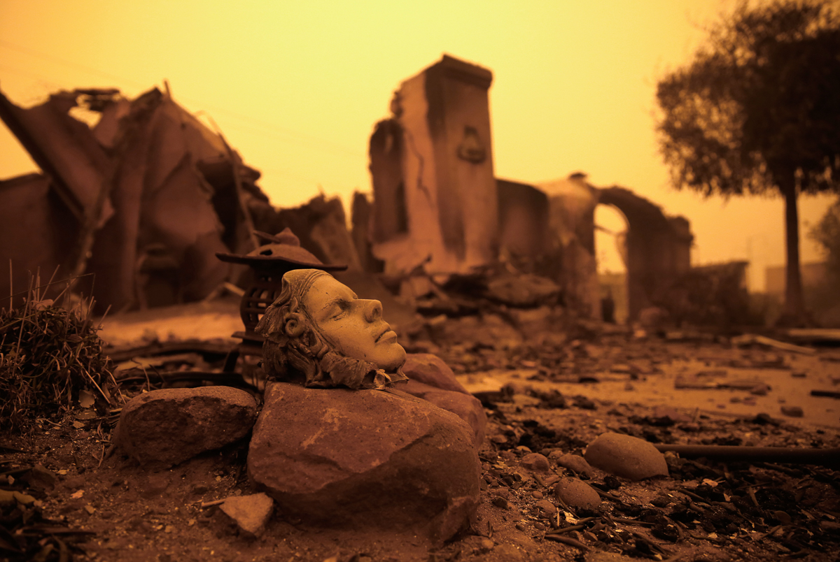 A piece of art sits outside the burned remains of home Friday, Nov. 9, 2018, that was destroyed by a wildfire that swept through the area Thursday, in Paradise, Calif. (AP Photo/Rich Pedroncelli)