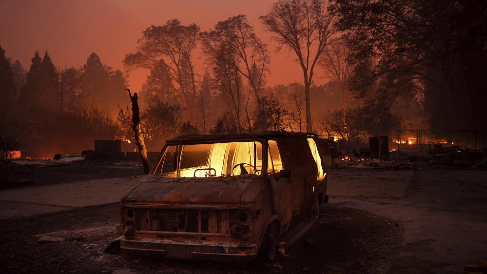 Flames burn inside a van as the Camp fire tears through Paradise, California, on Thursday, November 8, 2018