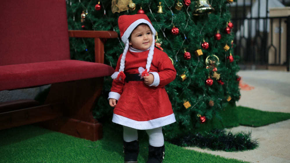 For some, lighting up the Christmas tree is a sign of hope for better things to come [Walid Mahmoud/Al Jazeera]