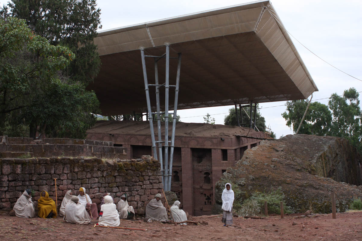 “We are admiring it, though the erosion is bad,” says Beliaish Siyum, standing with a friend on the ground overlooking Bet Medhane Alem, reputedly the world’s largest rock-hewn monolith, standing up