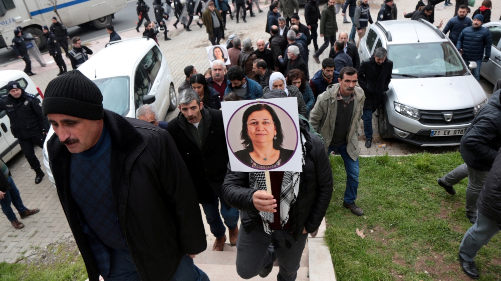 A supporter of pro-Kurdish HDP holds a picture of jailed lawmaker Leyla Guven, during a demonstration in solidarity with her, in Diyarbakir