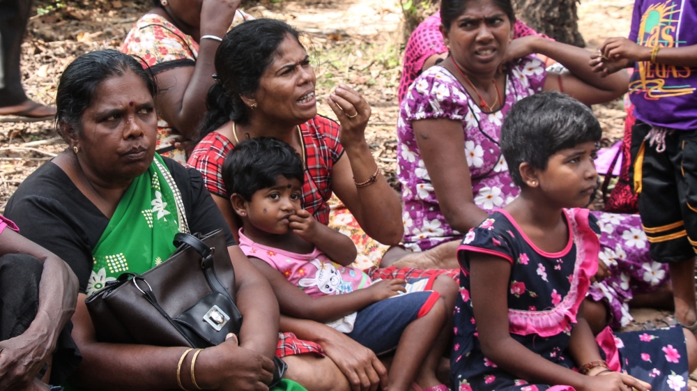 Community members occupy the space just outside the gate [Lisa Fuller/Al Jazeera] 