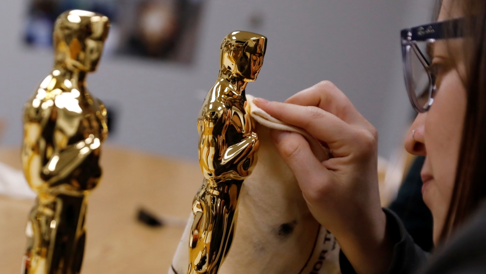 A finished Oscar statuette is polished by Stephanie Minor, project coordinator, at Polich Tallix foundry in Walden, New YorK