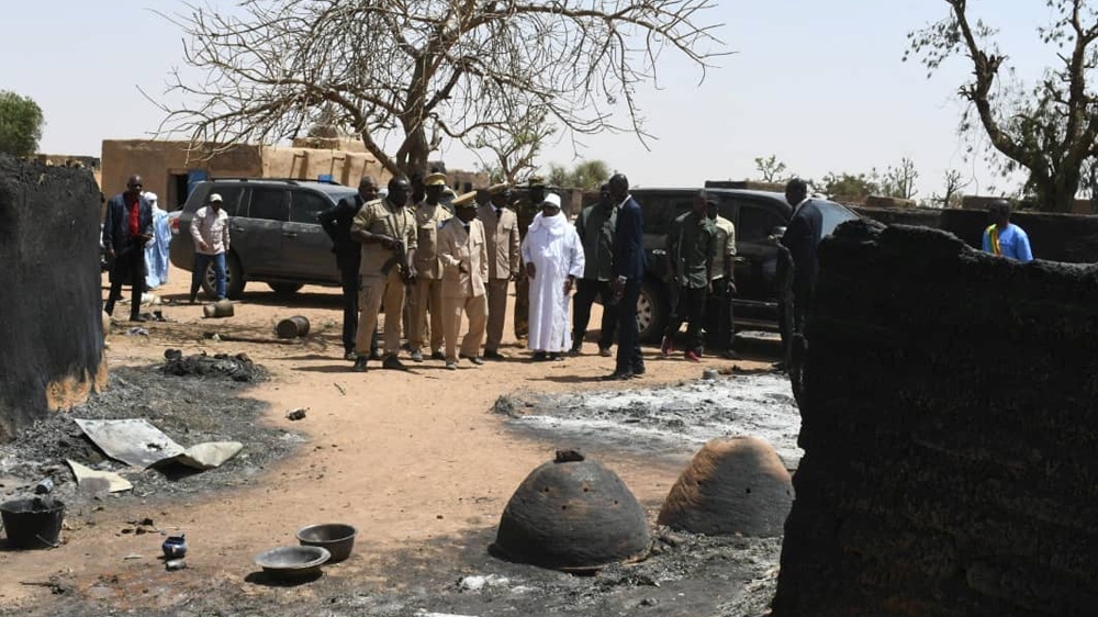 Mali’s President Ibrahim Boubacar Keita inspects the damage after an attack by gunmen on Fulani herders in Ogossagou, Mali in March of 2019 that killed at least 160 people