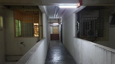 The hallway outside Amira's flat in a gargantuan apartment block housing hundreds of Yemeni and other migrant families [Al Jazeera]