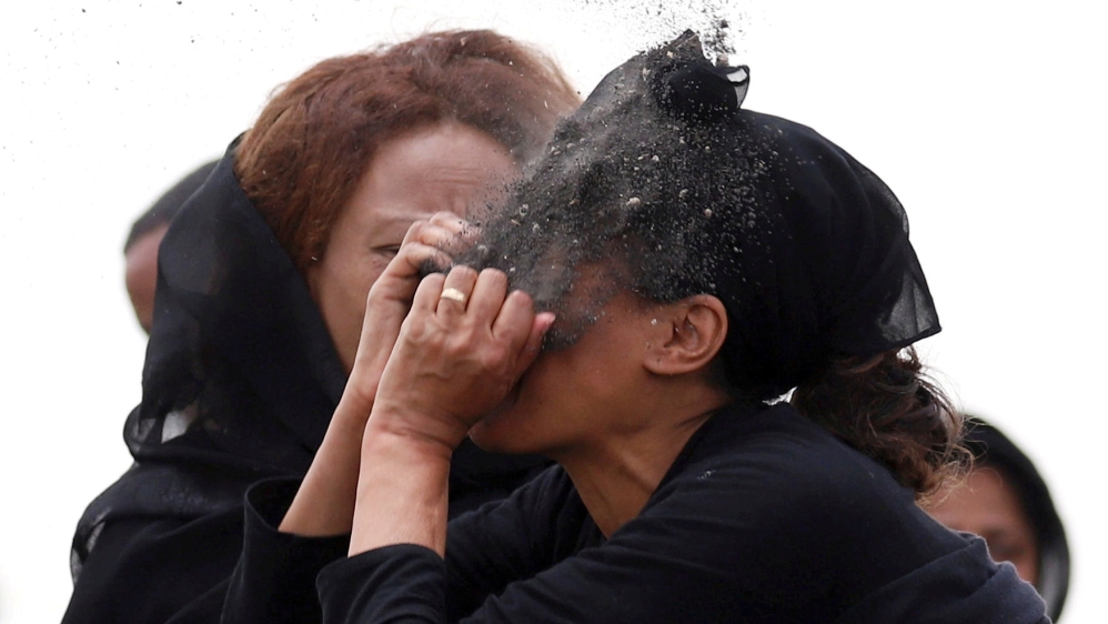 A relative puts soil on her face as she mourns at the scene of the Ethiopian Airlines Flight ET 302 plane crash near Addis Ababa, Ethiopia on March 14, 2019.