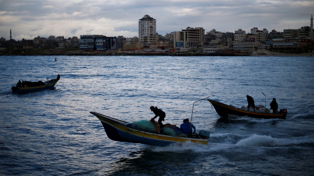 Palestinian fishermen ride boats at the seaport of Gaza City in 2019