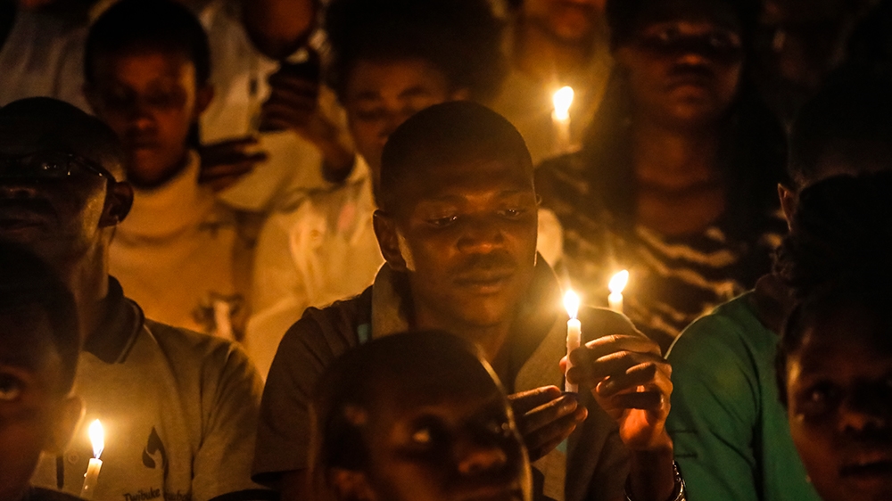 People hold candles during a vigil for victims of the 1994 genocide at Amahoro Stadium in Kigali, Rwanda [EFE/DAI KUROKAWA/EPA]