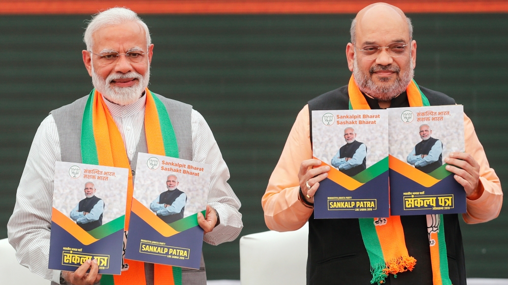 Indian PM Narendra Modi and chief of India''s ruling Bharatiya Janata Party (BJP) Amit Shah, display copies of their party''s election manifesto for the April/May general election in New Delhi
