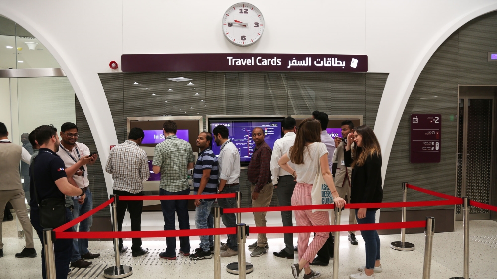 Commuters line up to buy tickets for their first ride [Showkat Shafi/Al Jazeera] 