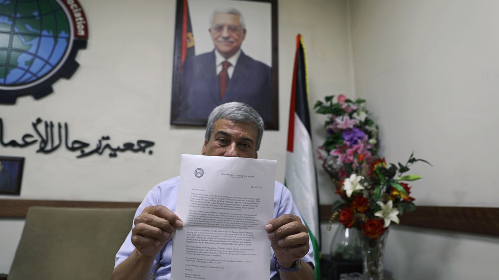 Palestinian businessman Abed Alkarim Ashour shows the invitation letter for the Bahrain conference from the United States Department of the Treasury