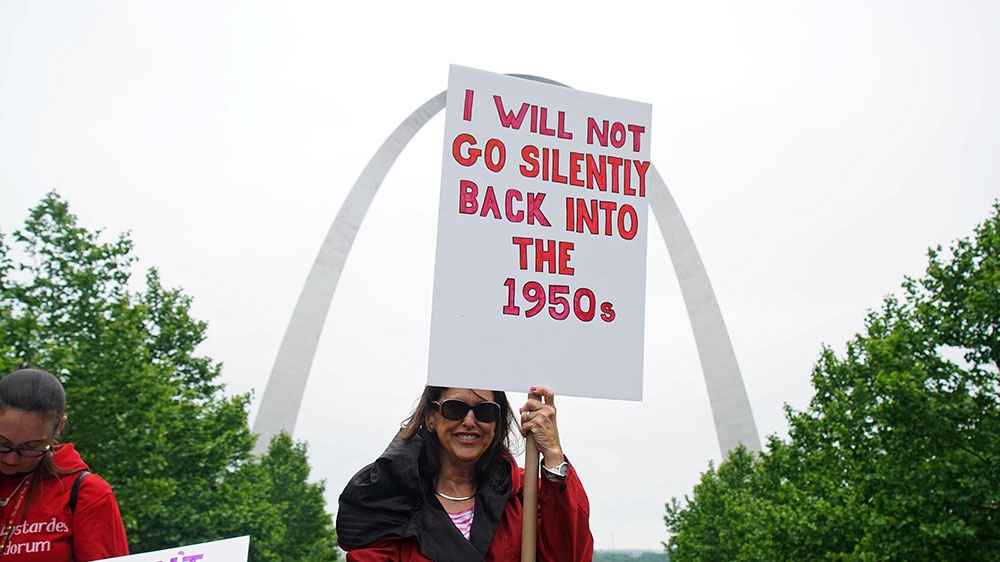A woman holds up a sign as hundreds of women protest on the steps of the Old Court House during a Stop the Abortion Ban Bill Day of Action in St Louis, Missouri