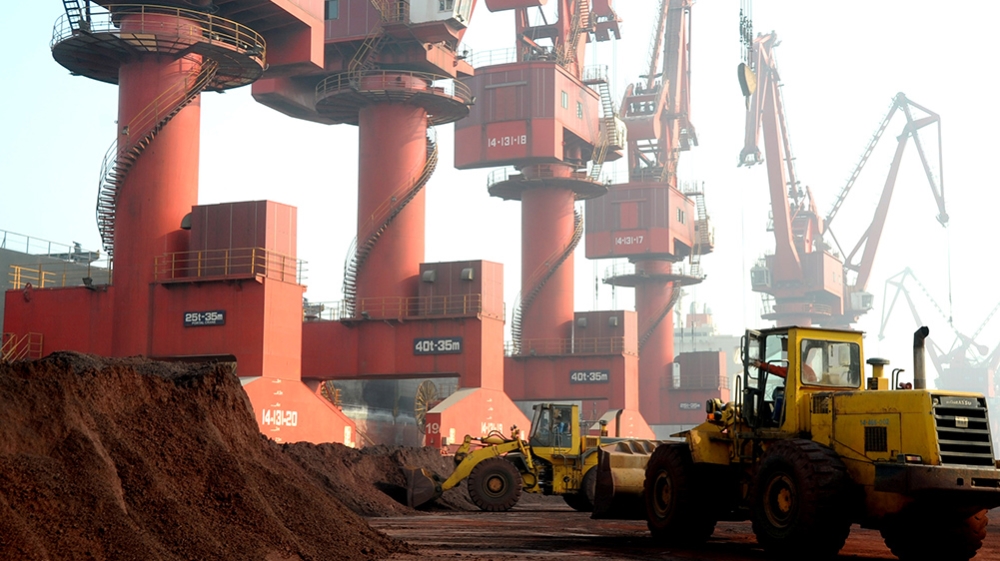 Workers transport soil containing rare earth elements for export at a port in Lianyungang, Jiangsu province, China in 2010