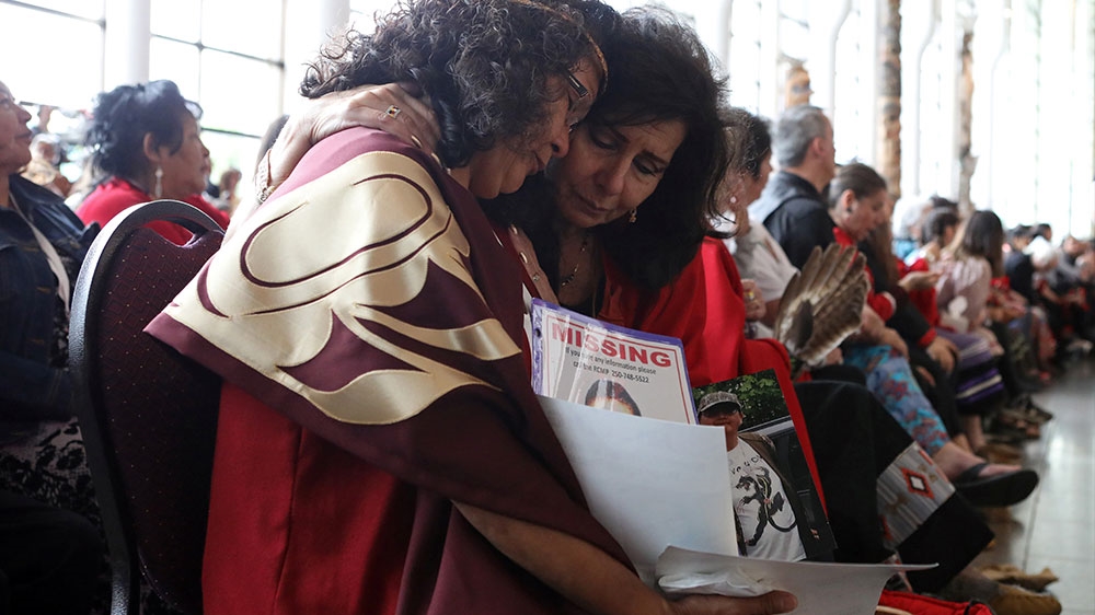 Women embrace during the closing ceremony of the National Inquiry into Missing and Murdered Indigenous Women and Girls in Gatineau, Quebec