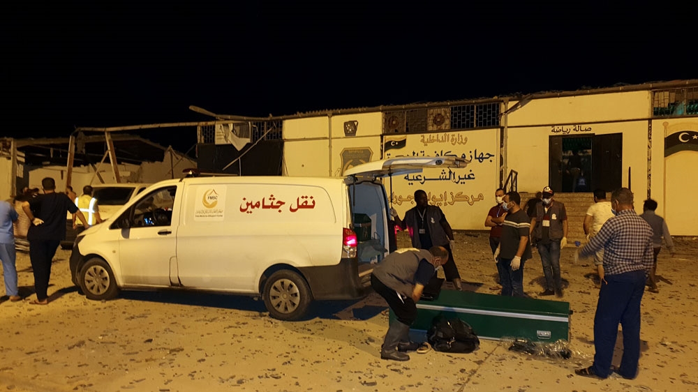 Emergency workers recover bodies after the air attack killed dozens