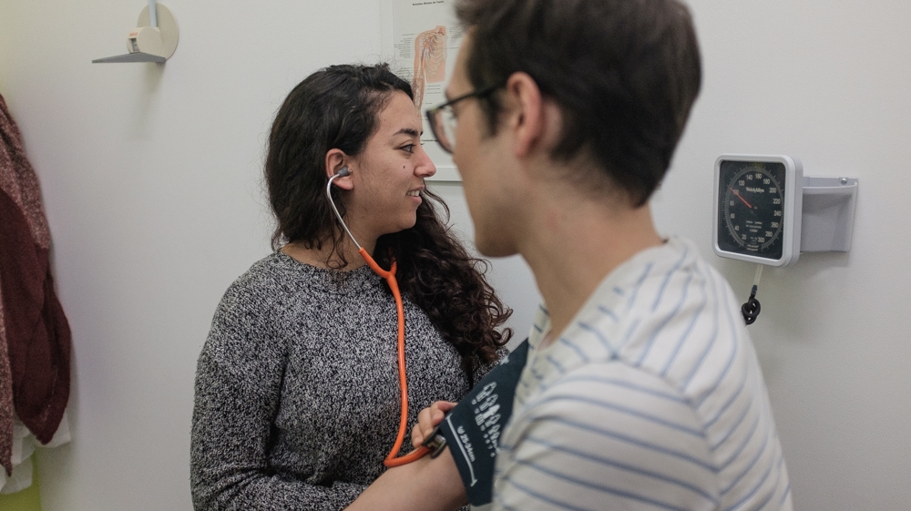 Hind Addi examines a patient in a doctor’s office in Molenbeek. The GP estimates that residents of the neighbourhood live 20 years less in good health than those of another, wealthier part of Brussels