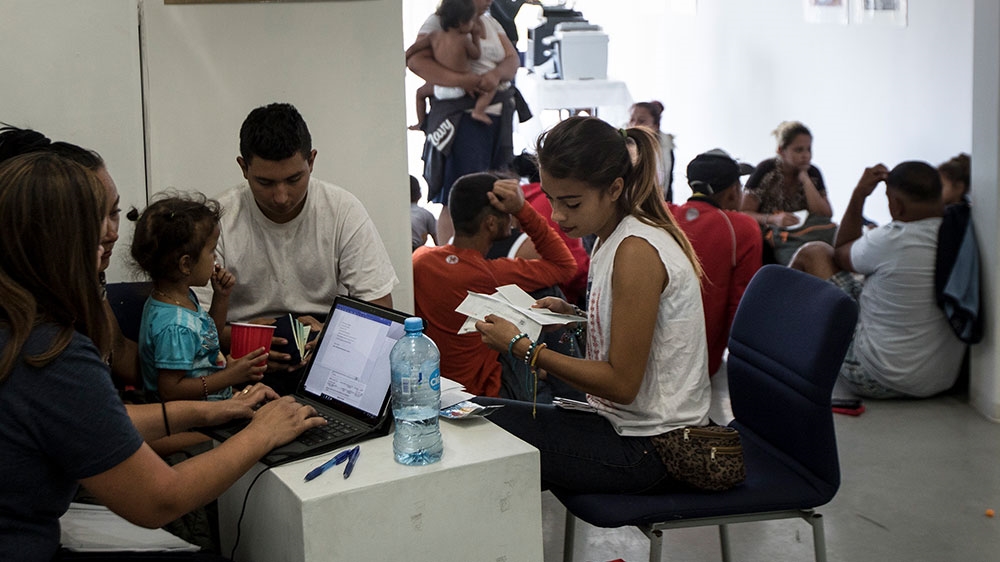 A US volunteer lawyer informs migrants on what to expect when requesting asylum in the US, at an office in Tijuana, Mexico