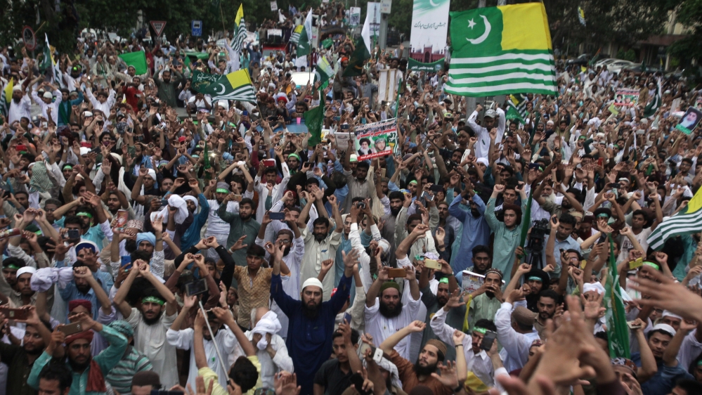 Supporters of the Tehrik-e-Labaik Pakistan political party chant slogans as they wave flags during a rally to express solidarity with the people of Kashmir, in Lahore