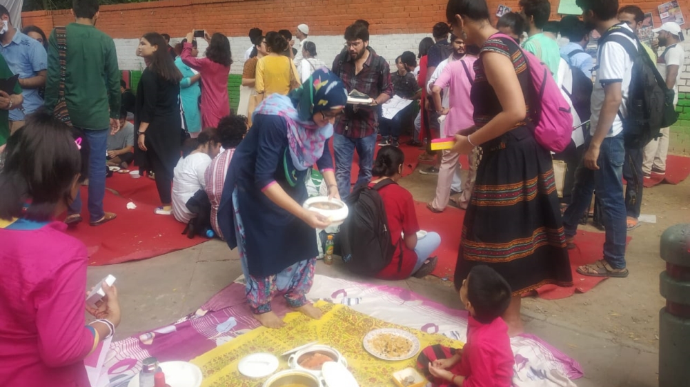 People distribute food at an Eid event held in solidarity with Kashmiris in New Delhi [Al Jazeera]